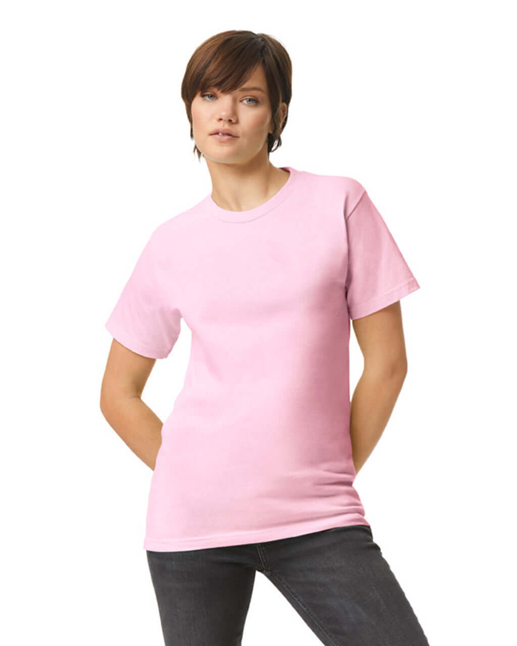 Model wearing a pink unisex heavyweight cotton t-shirt, showcasing its versatility and style.