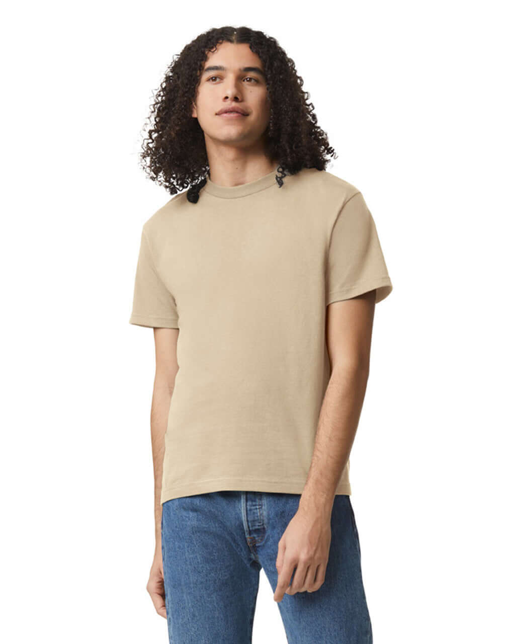 Model wearing a sand unisex heavyweight cotton t-shirt, showcasing its versatility and style.