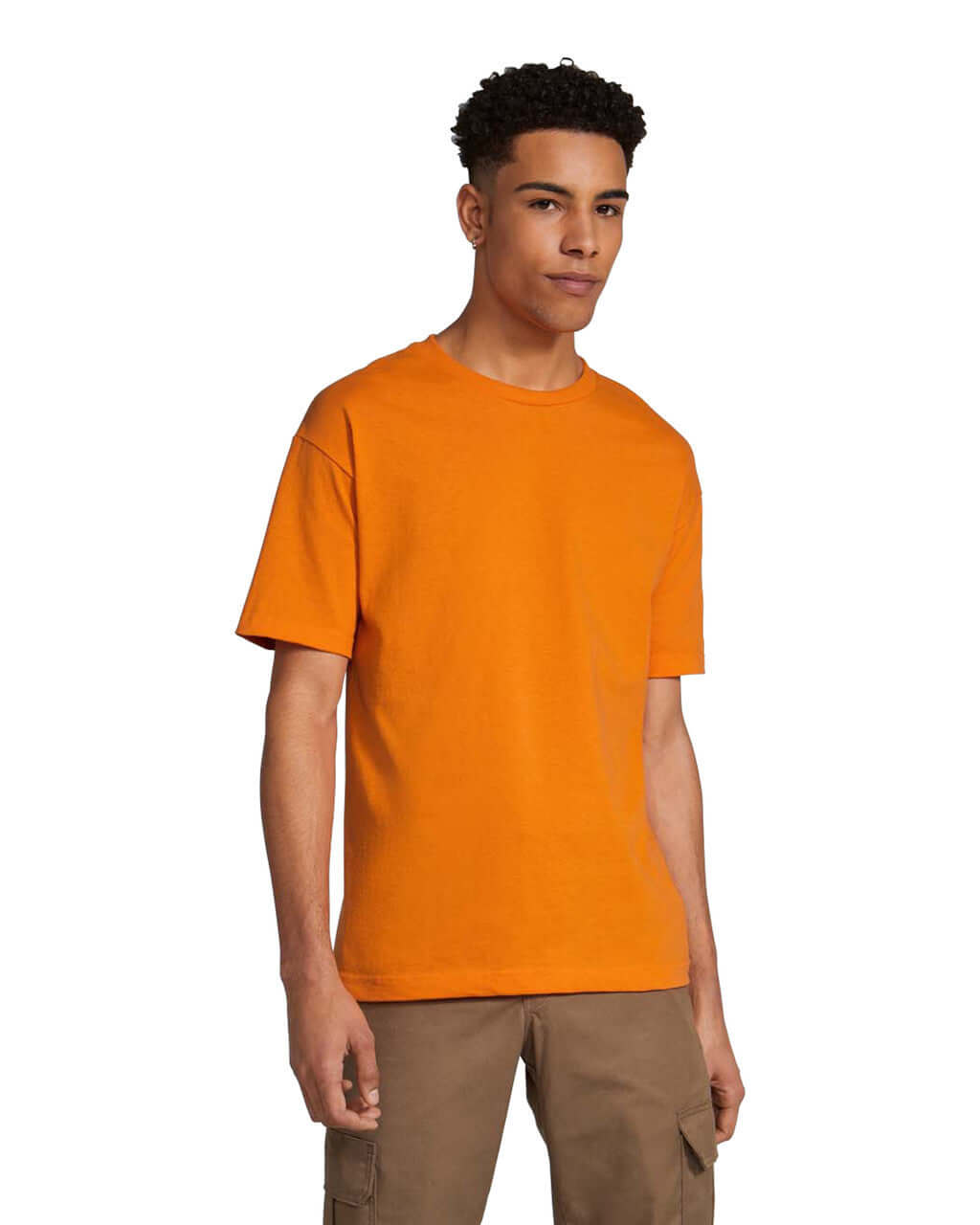 Model wearing a orange unisex heavyweight cotton t-shirt, showcasing its versatility and style.