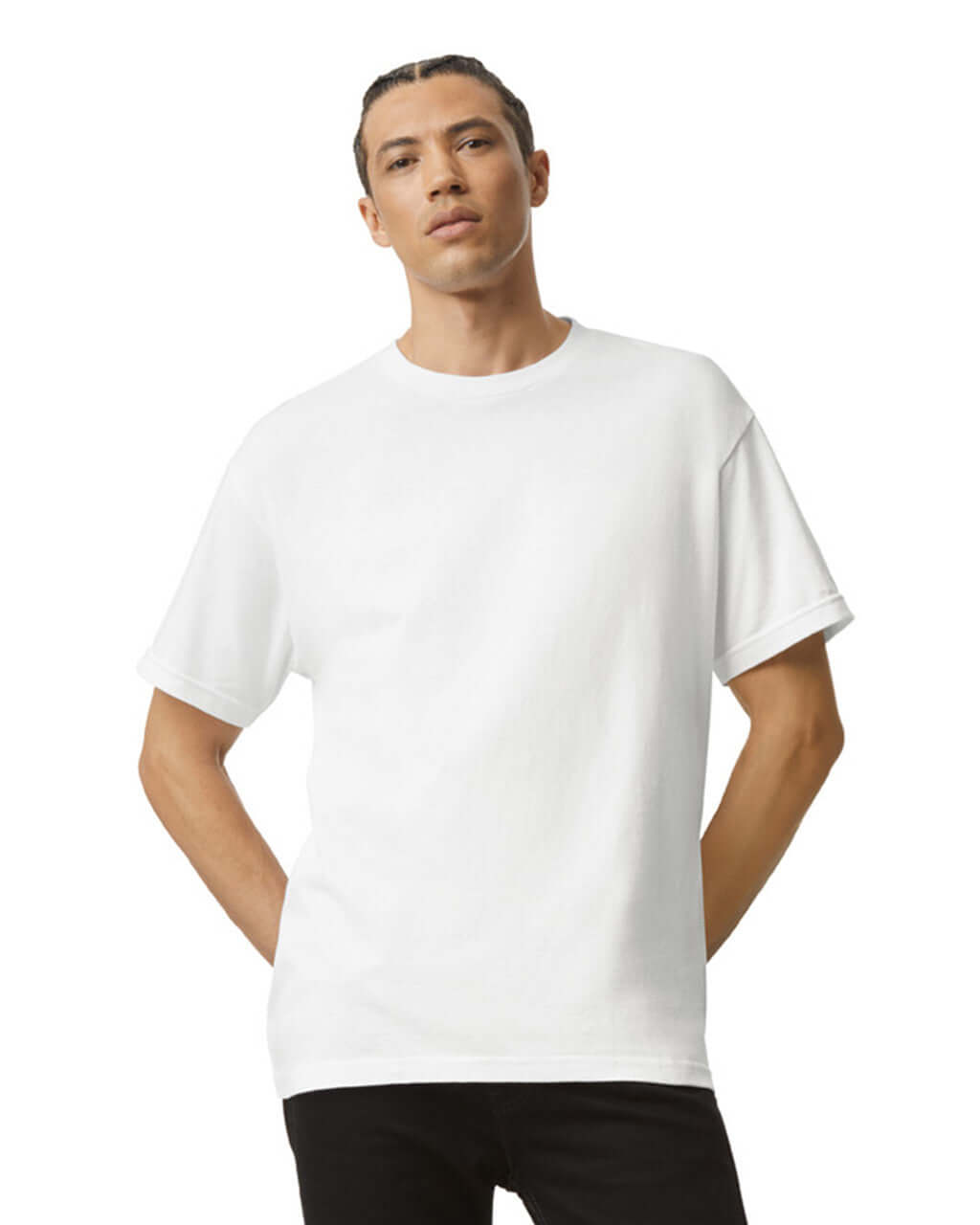 Model wearing a white heavyweight cotton unisex t-shirt from American Apparel, showcasing its relaxed fit and durability.