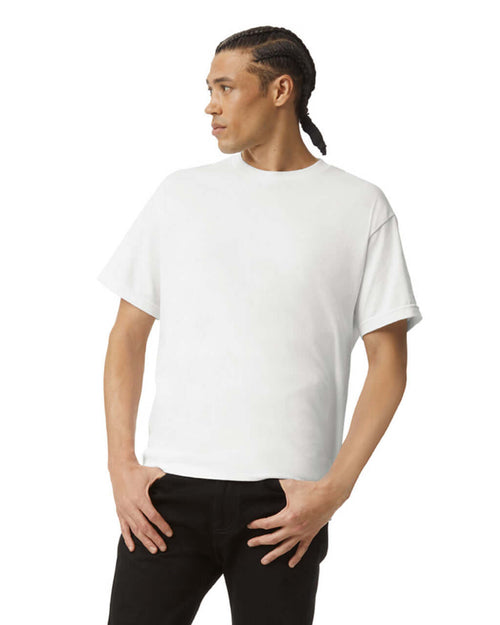 Model wearing a white unisex heavyweight cotton t-shirt, showcasing its versatility and style.