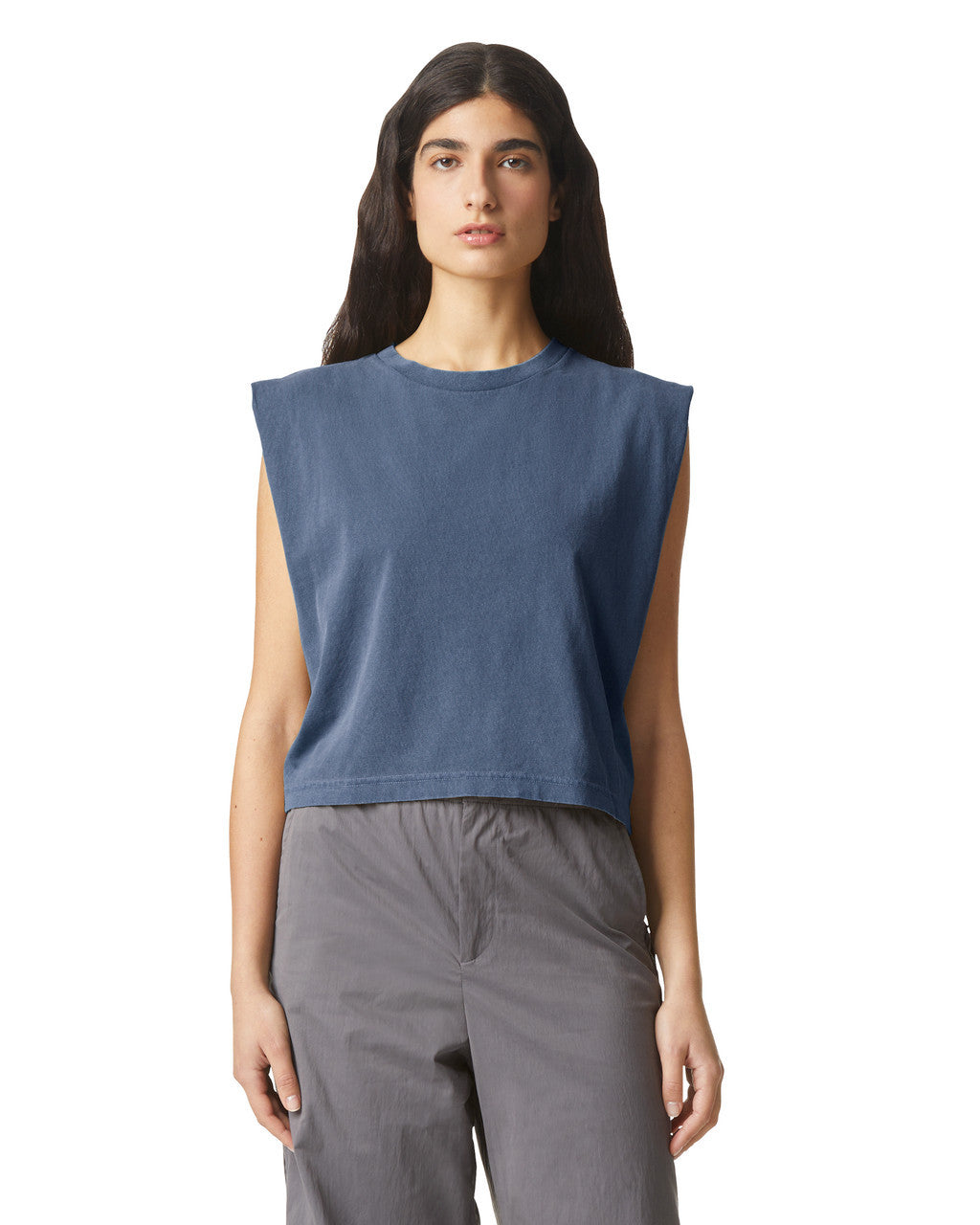 Model wearing AMERICAN APPAREL Heavyweight Garment Dyed Muscle T-Shirt in navy, styled with high-waisted jeans.