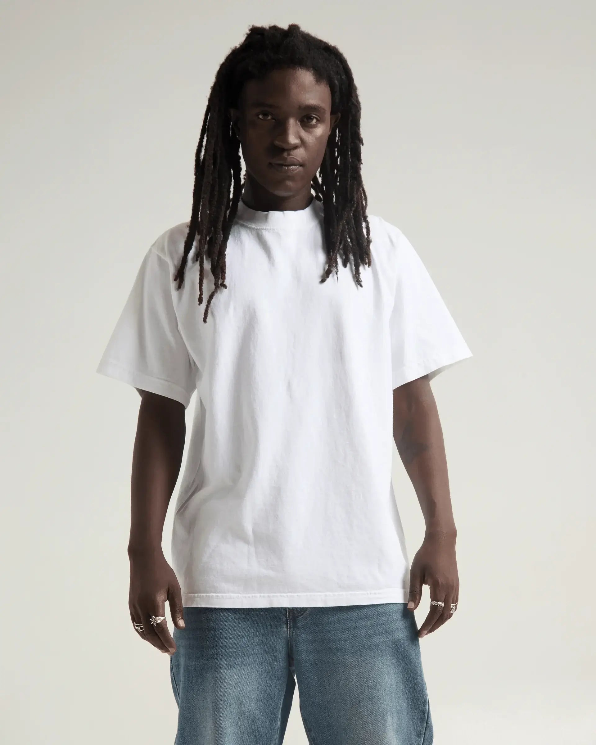 Model wearing a white SHAKA WEAR MAX HEAVYWEIGHT GARMENT DYE tee with an oversized fit.