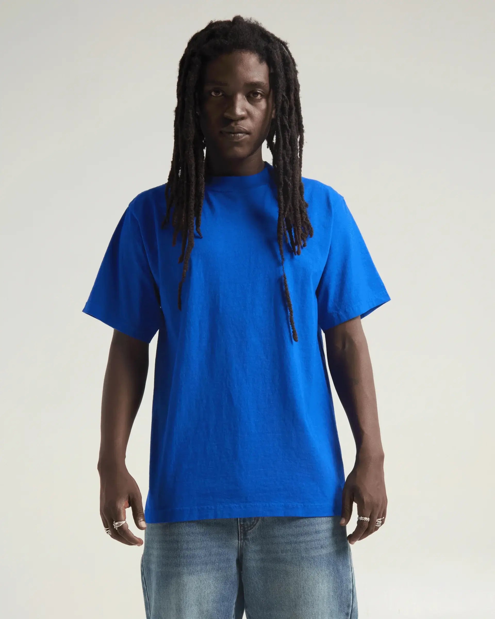 Model wearing blue SHAKA WEAR MAX HEAVYWEIGHT GARMENT DYE tee, showcasing its oversized fit and vibrant color.