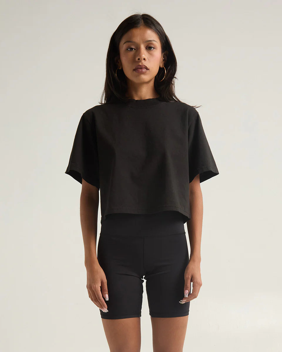 Black garment dye crop top styled with matching bike shorts, showcasing a modern and confident look.