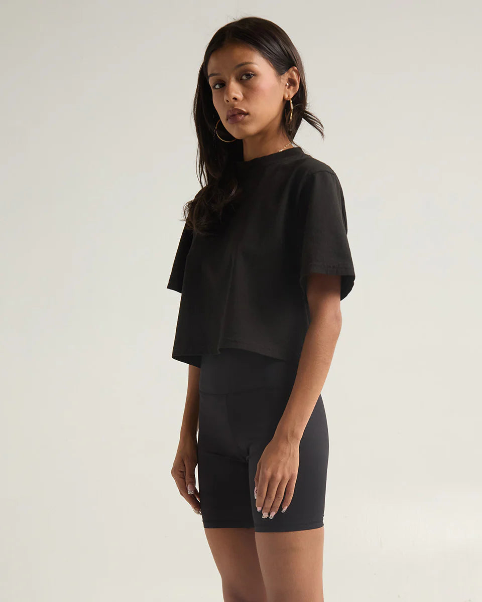 Black garment dye crop top styled with high-waisted bike shorts, showcasing a modern look and expert craftsmanship.