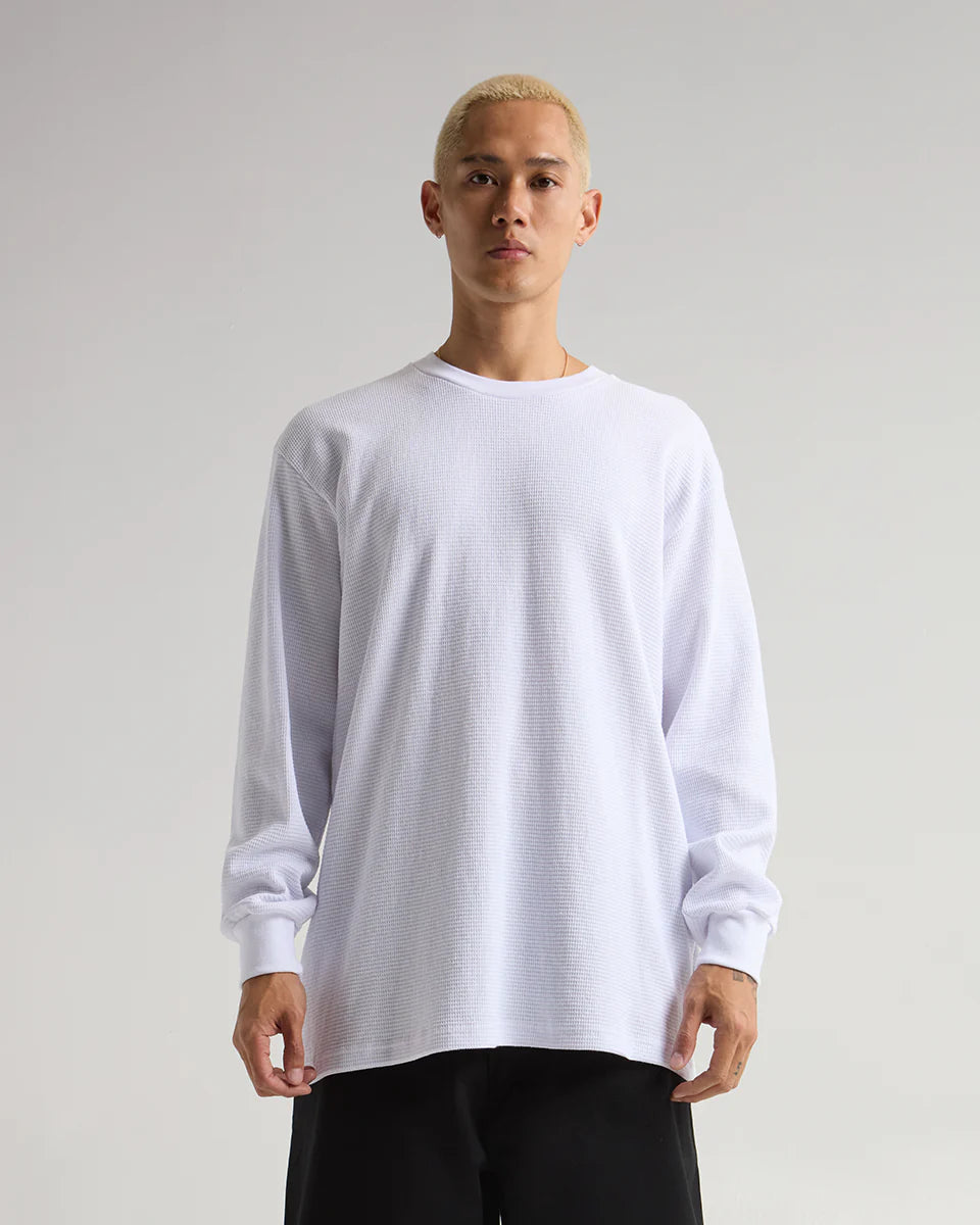 Model wearing a white SHAKA WEAR heavyweight thermal shirt, showcasing its breathable and durable design.