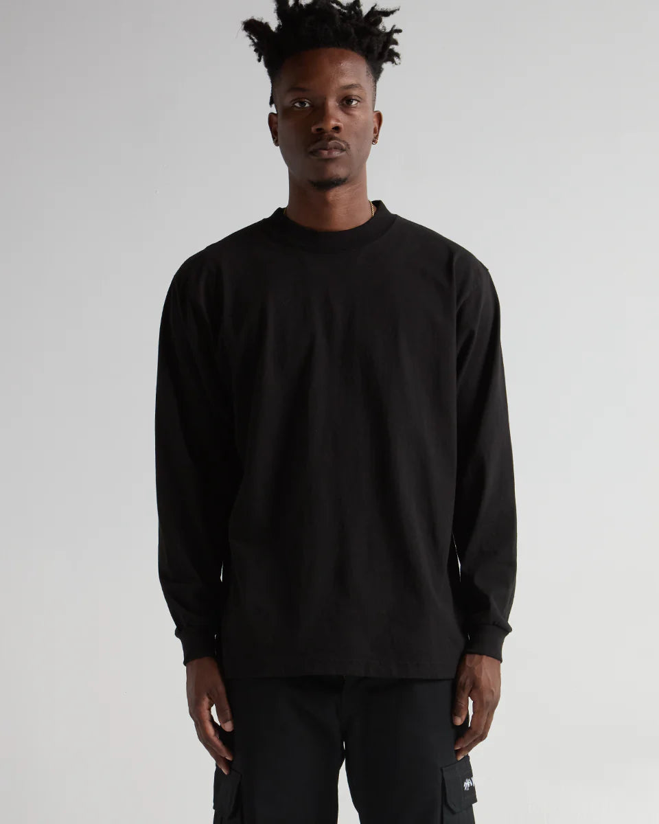 Black long sleeve shirt on a model, showcasing premium streetwear style and durable construction.