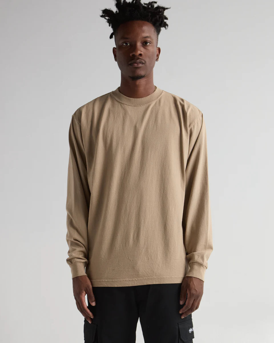 Model wearing MAX HEAVYWEIGHT GARMENT DYE LONG SLEEVE in beige, showcasing premium streetwear style and durability.