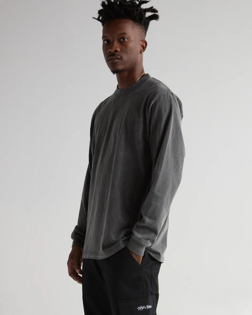 Man wearing a MAX Heavyweight Garment Dye Long Sleeve in washed-out charcoal, showcasing streetwear style and durability.