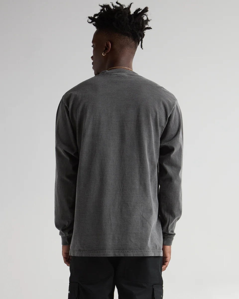 Back view of a model wearing the MAX Heavyweight Garment Dye Long Sleeve in washed-out gray, showcasing its durable design.