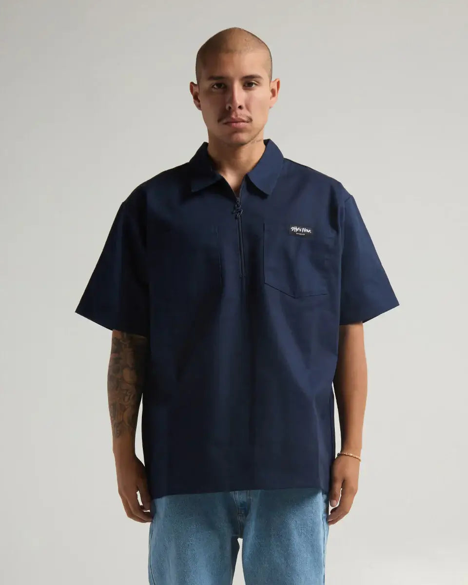 Man wearing navy SHAKA WEAR WORK SHIRT, featuring a stylish zipper and durable fabric for versatile performance.